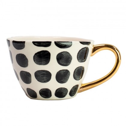 elegante taza de gres con un esmaltado de topos blanco y negro