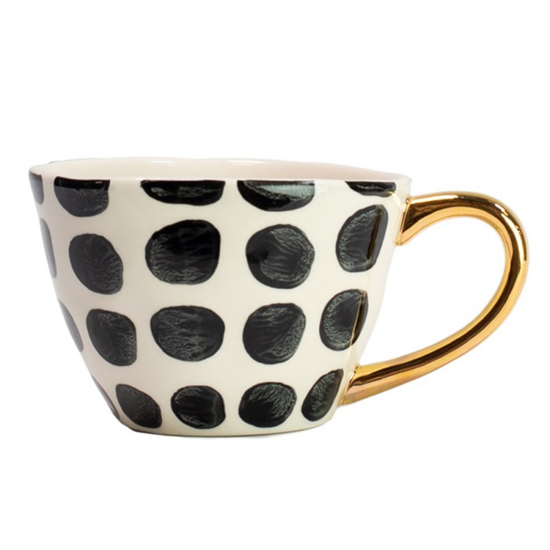 elegante taza de gres con un esmaltado de topos blanco y negro